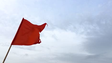 hindu religious flag which is associated with hndu god on top of the temple