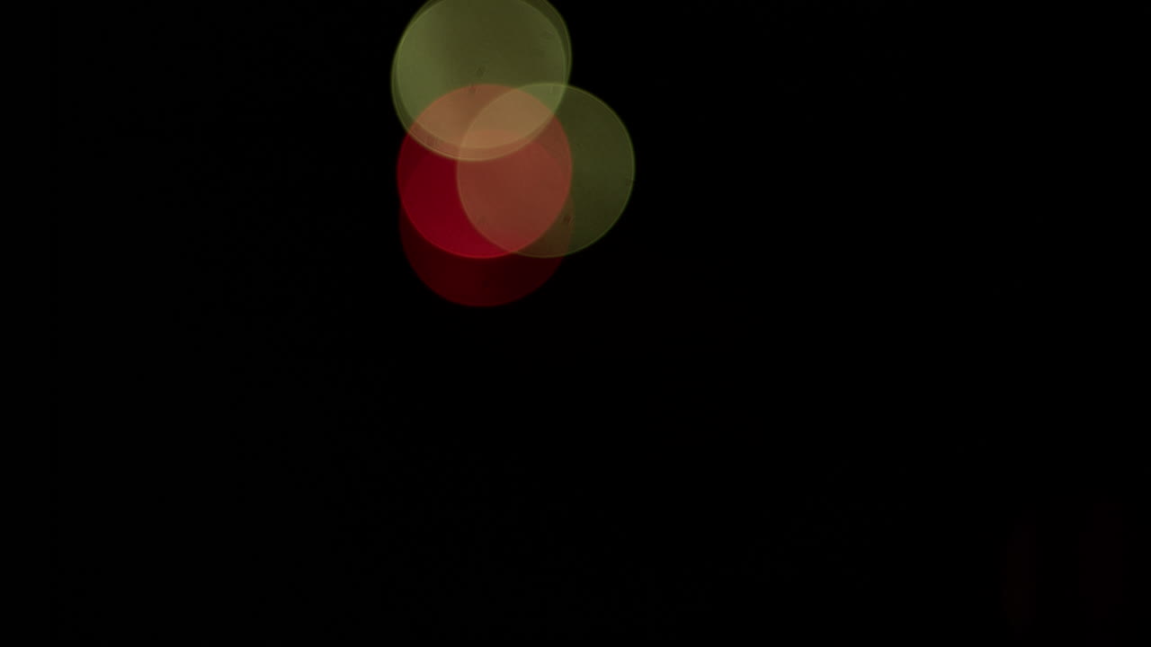 Wide shot of bokeh patterns created by out-of-focus fireworks in the distance