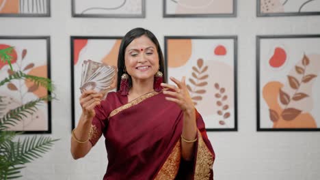 wealthy indian woman use money as fan