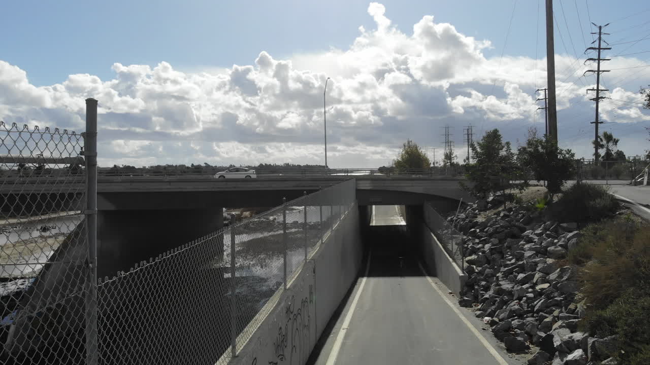 Bike Path Along a River Under a Highway Overpass