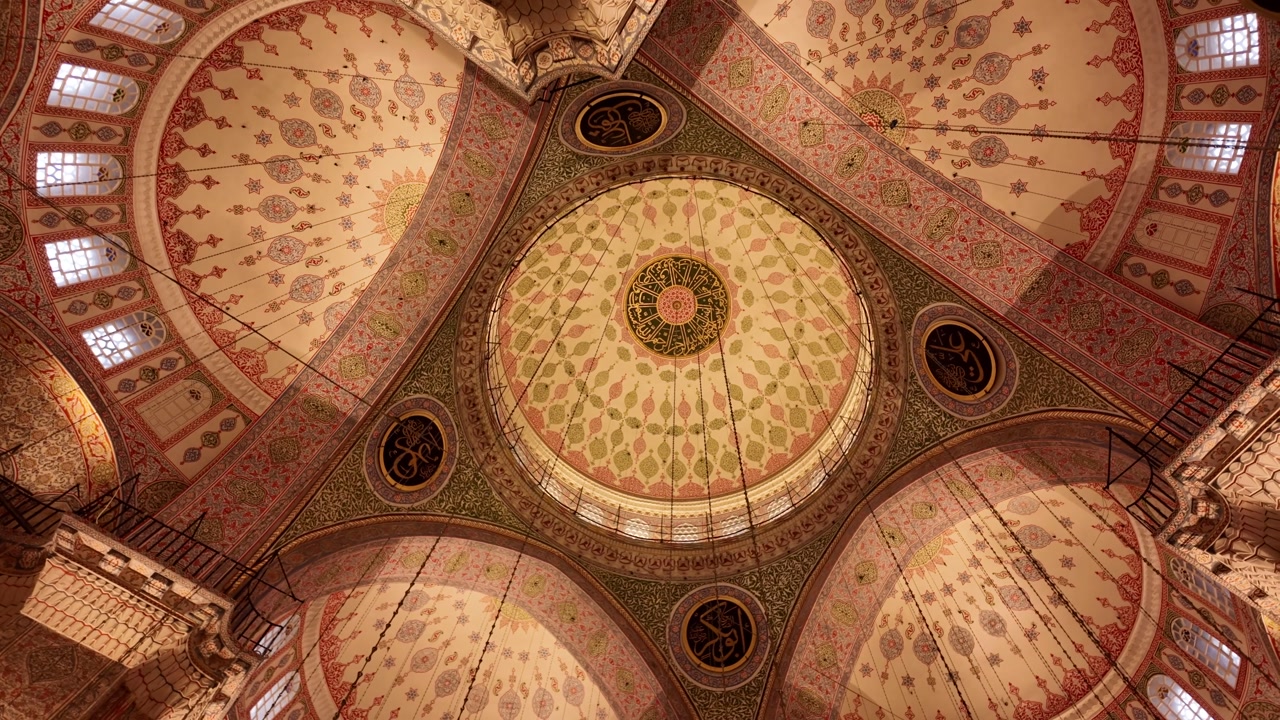 Ornate Domes and Intricate Islamic Calligraphy Adorn a Mosque Ceiling