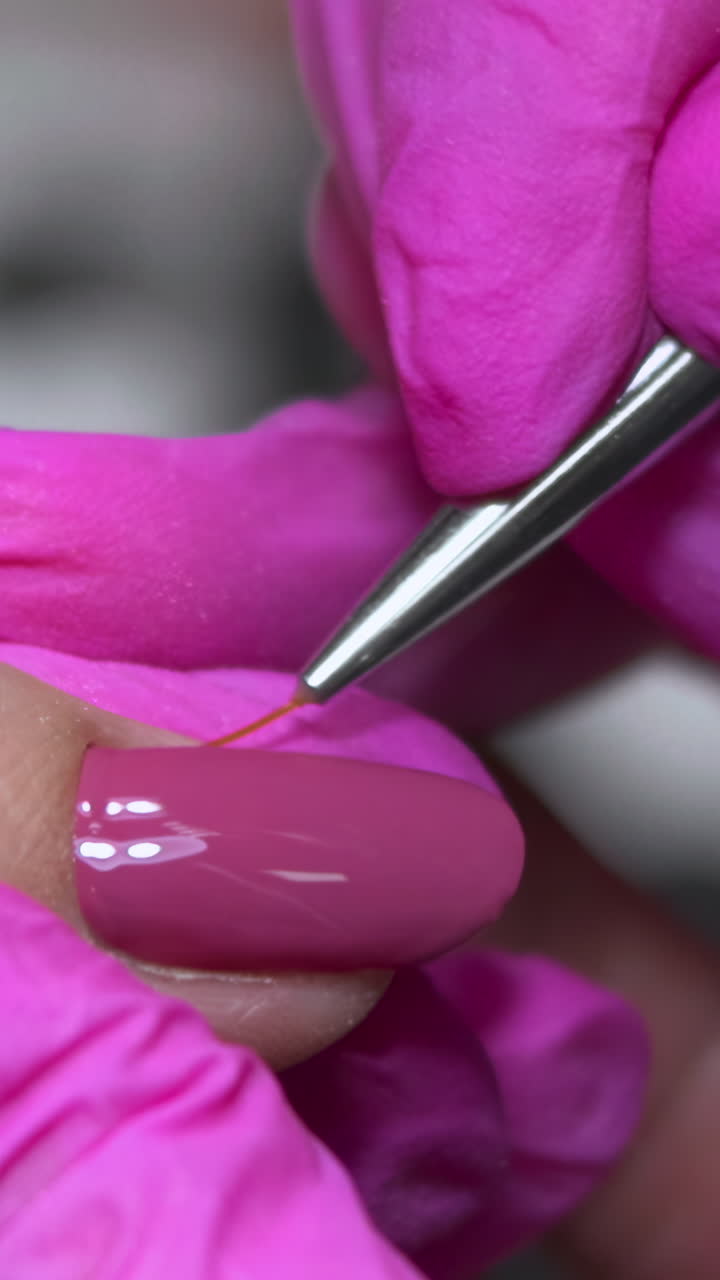 Closeup Nail Technician Performs Precise Cuticle And Polish Work On Caucasian ClientS Hand, PinkGloved. Media