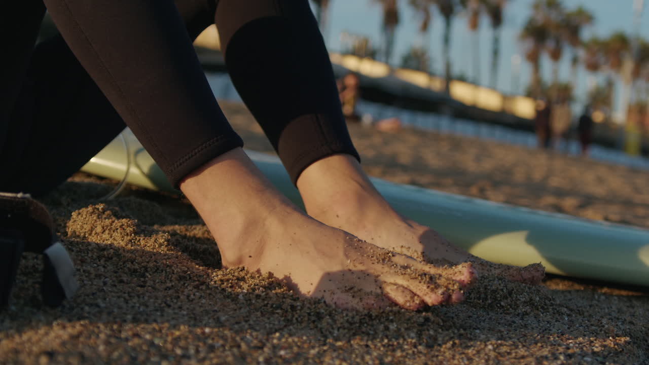 Surfer man walking to the beach at sunset preparing for surfing training and search for waves in Barcelona, spain, water, ocean exercise in sea with board, athletic male holiday or travel in vacation