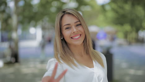 girl waving hand and smiling at camera