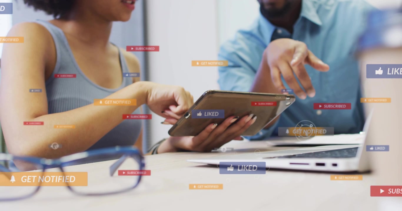 Man pointing, floating labels popping and stacking while woman tapping tablet, showing metrics