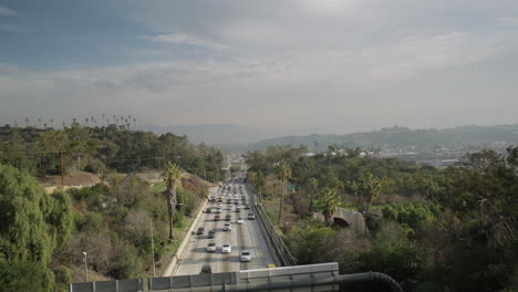 panning across a busy california highway at rush hour on a sunny day.