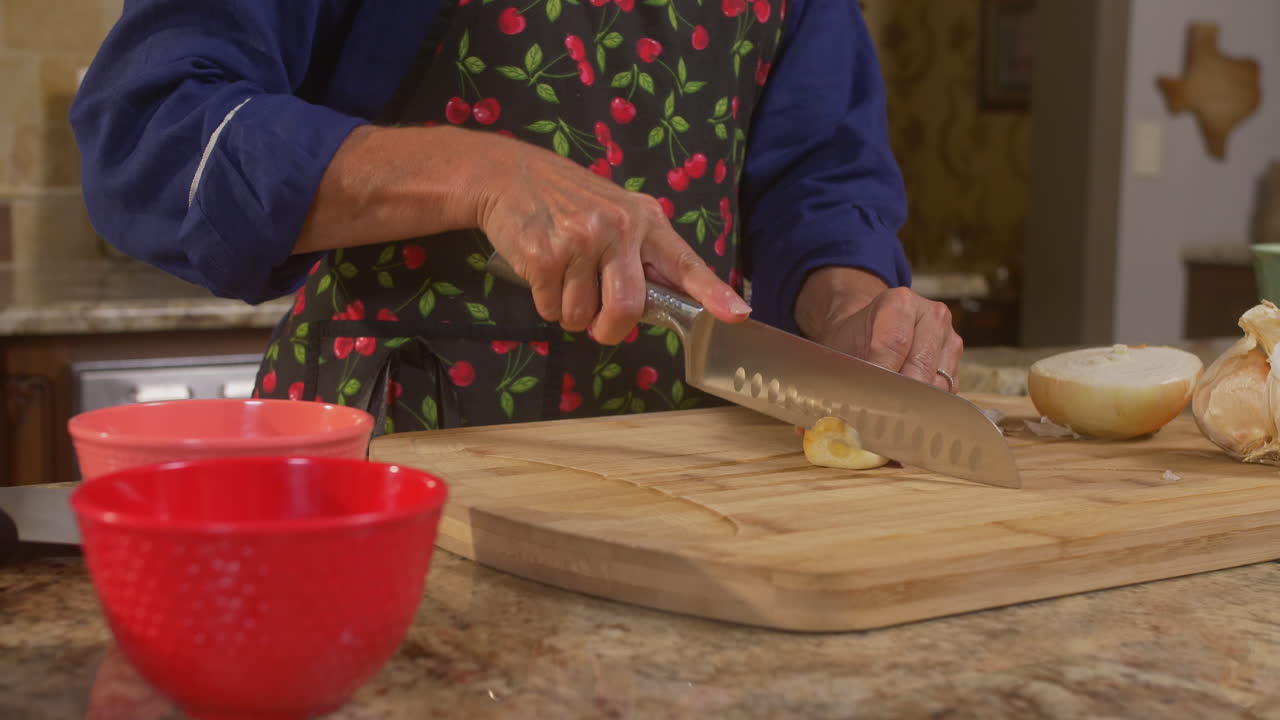 Woman's chopping vegetables on a cutting board