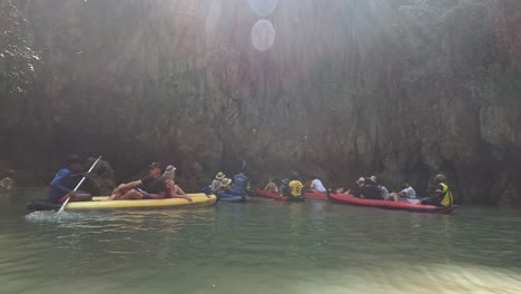 tourists on a guided boat adventure in a cave