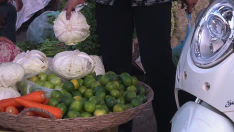 close of person choosing a cabbage to buy