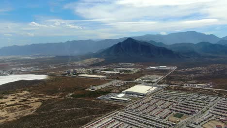 panoramic view of monterrey in mexico with thousands of low houses and mountains background
