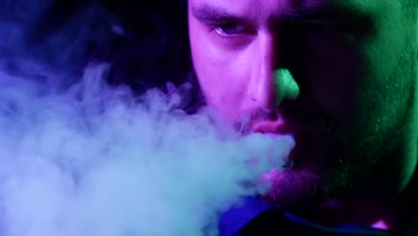 the mouth of a man smoking the traditional hubblebubble or hookah closeup of man with a beard smoking traditional hookah pipe man exhaling smoke on black background