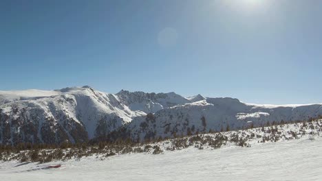 Ski-slope-and-horizon-of-mountains-covered-with-snow