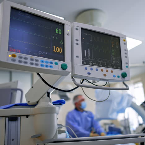 monitoring condition of a patient under operation. screens of lung ventilating machine displaying life signs. low angle view.