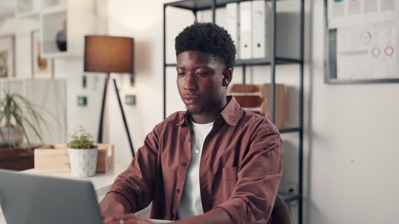 Man working with laptop and documents in an office
