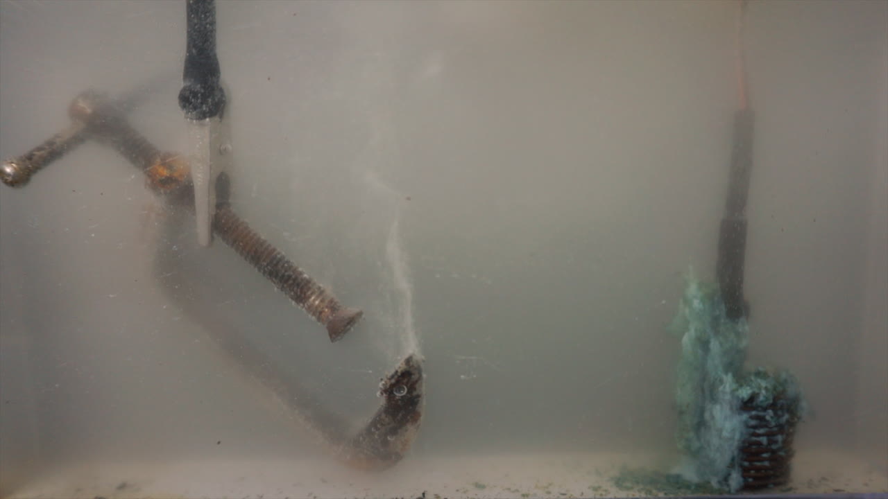 Electrolysis used to clean a rusty c-clamp seen in timelapse