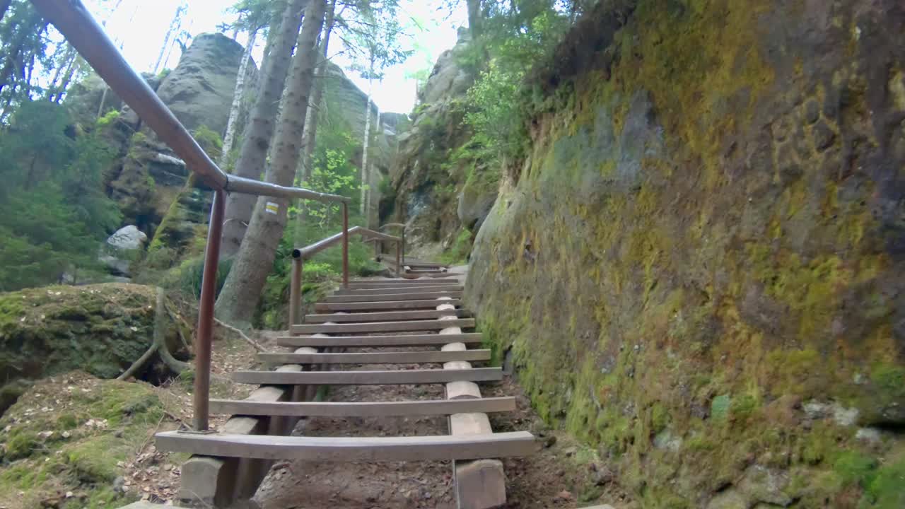 Walking up wooden stairs in between rocks in national park Adr&scaron;pach