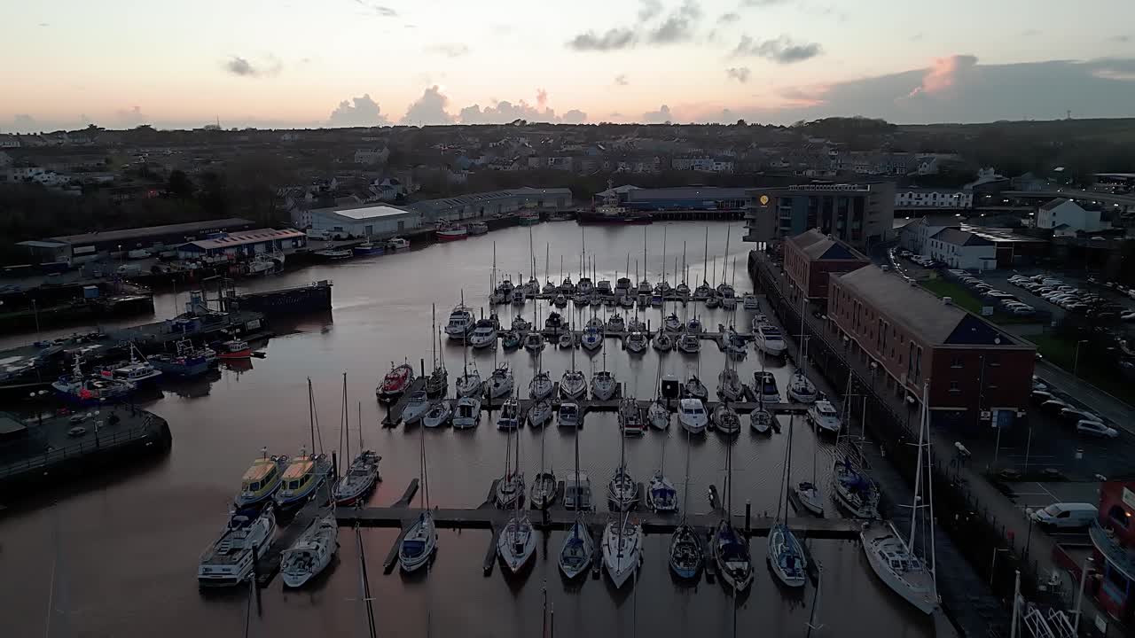Quiet marina at sunset with boats docked in Milford Waterfront, Pembrokeshire