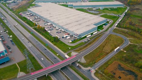 warehouses, huge logistics center near the highway, view of a large number of cargo trailers and containers, international cargo transportation, aerial view