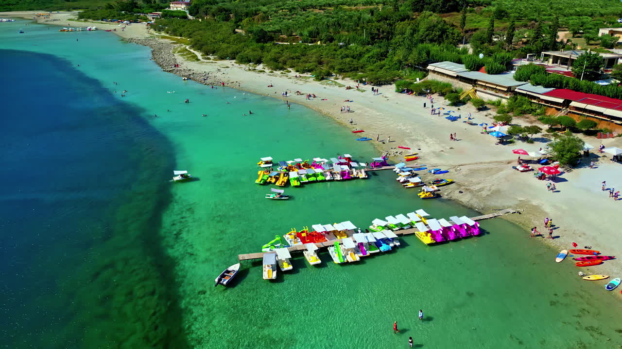 Aerial View of a Beautiful Beach with Turquoise Water and Colorful Pedal Boats