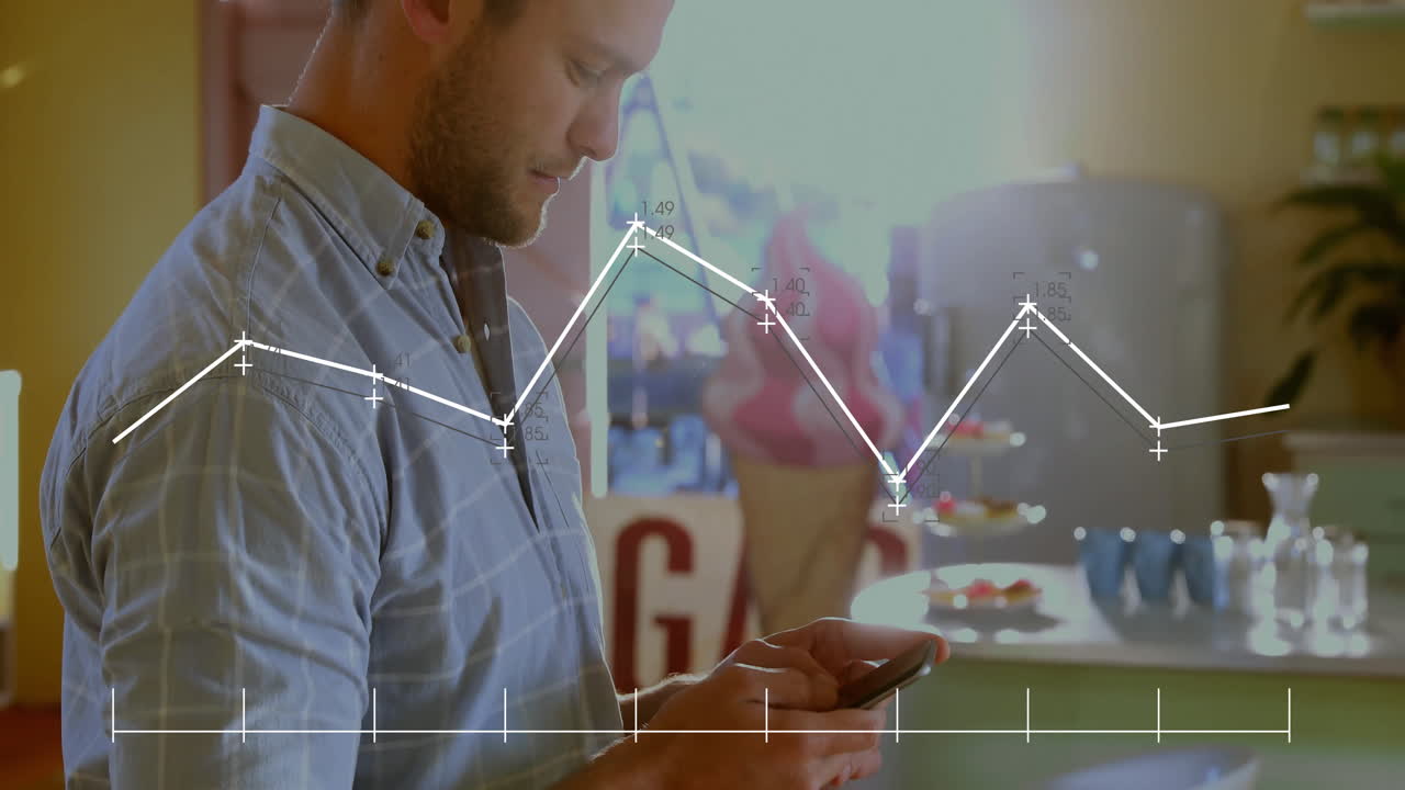 Mid-adult man tapping smartphone at cafe counter, visualizing business data via line graph overlay