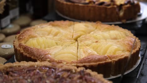 Warm-apple-pie-with-brown-crust-placed-on-bakery-stall-during-food-market-in-London