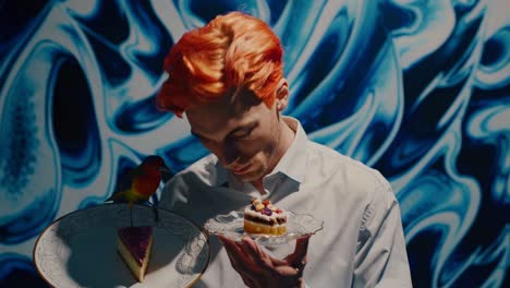 man with orange hair holding dessert and bird