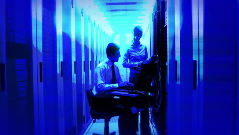 animation of blue shade over caucasian workers in server room