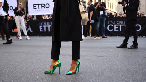 person wearing vibrant green high heels at a fashion event
