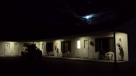 establishing shot of a roadside motel under a full moon at night 2