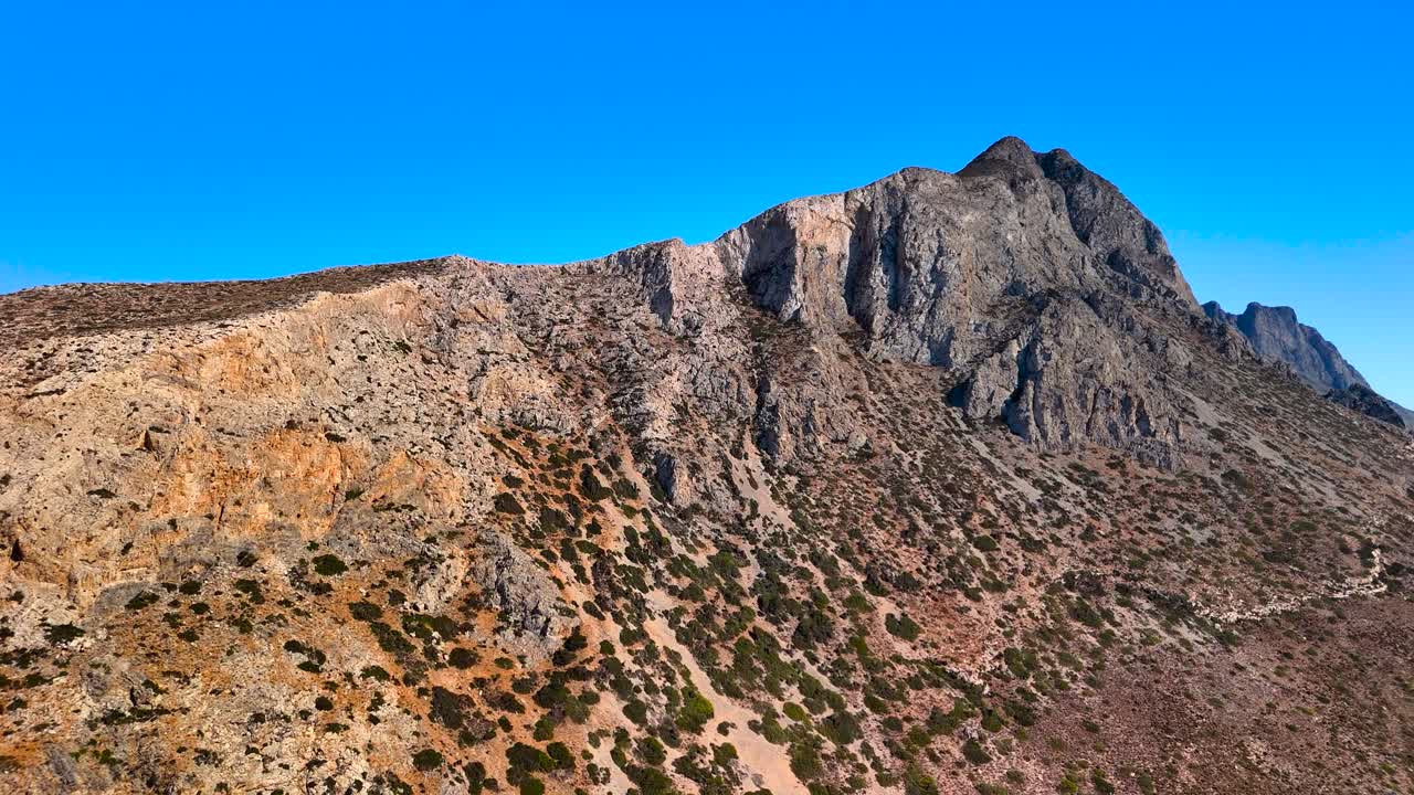 Beautiful mountain landscapes showcase rugged terrains under a bright blue sky. The natural beauty of this location invites outdoor exploration and adventure