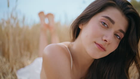 brunette woman posing field nature portrait. young barefoot lady relaxing summer