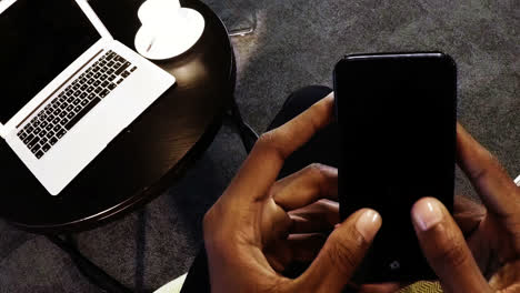 Hands-of-a-businesswoman-using-mobile-phone