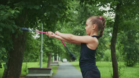a young girl practicing precision and coordination with sports equipment in a lush green park setting, focusing on skill development and active lifestyle