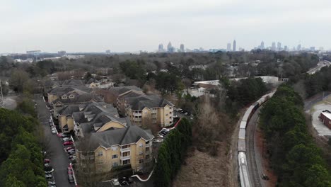 atlanta skyline reveal. moving train near apartments