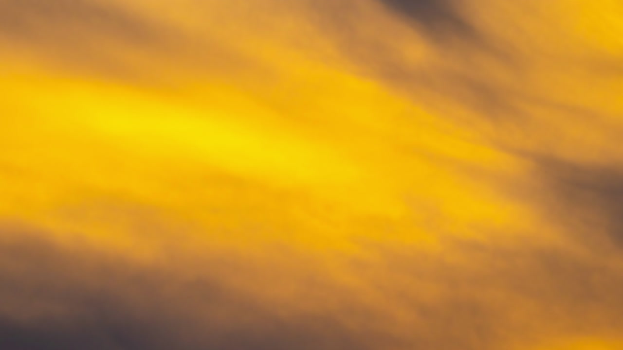 Golden sunrise clouds moving fast, evoking hope and new beginnings