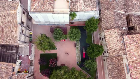 Aerial-top-down-view-of-a-square-in-a-small-Italian-town