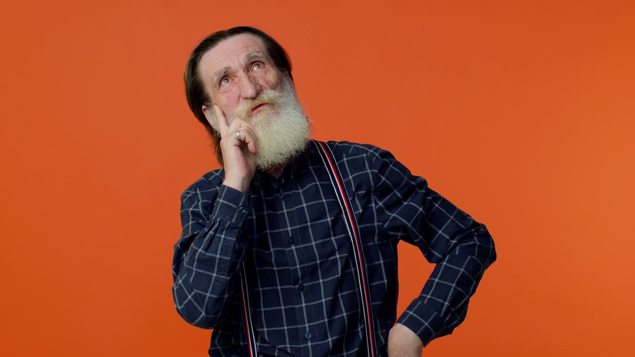Doubting pensive mature old grandfather pondering, imagining in mind, wondering difficult solution