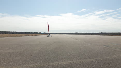 Low-angle-footage-of-Land-Sailing-buggy-heading-towards-camera-before-turning-away