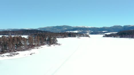 Aerial-Panoramic-View-Of-A-Snowscape-In-Forest-And-Mountains-During-Winter-Season