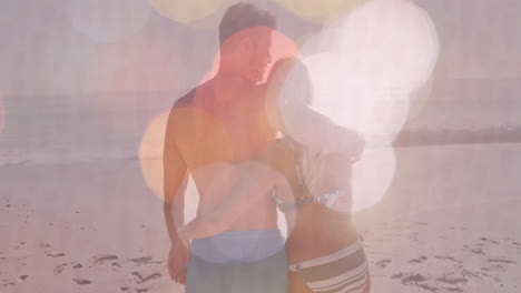 embracing on beach, couple with bokeh light effect creating romantic animation