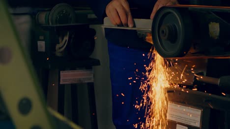 worker shaping metal on machine 4k