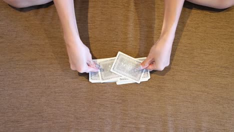 hands expertly shuffling a deck of cards