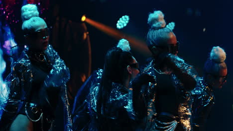 a female group performing live on stage at a concert