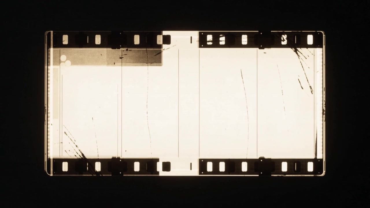 Baggrundslys tændes, belyser filmstrimmel i mørk port, viser perforeringer og ridser til analyse.