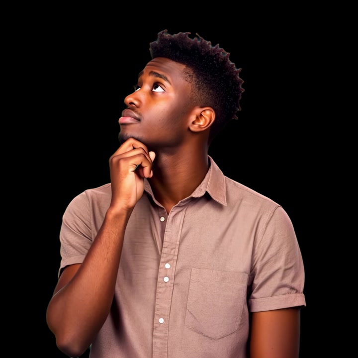 Young Man Thinking and Looking Upwards Against Black Background