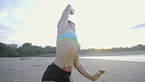 sporty woman warming up on beach