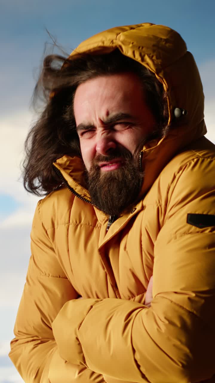 Bearded Man in Yellow Puffer Jacket Feeling Cold Outdoors