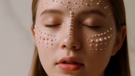 woman's face adorned with pearls