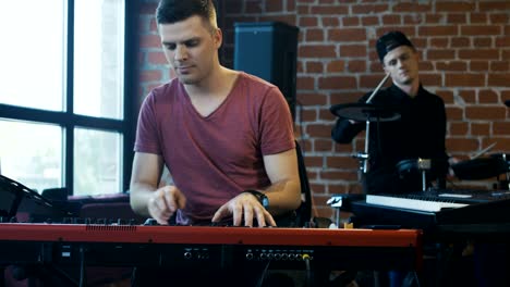 men playing musical instruments in studio