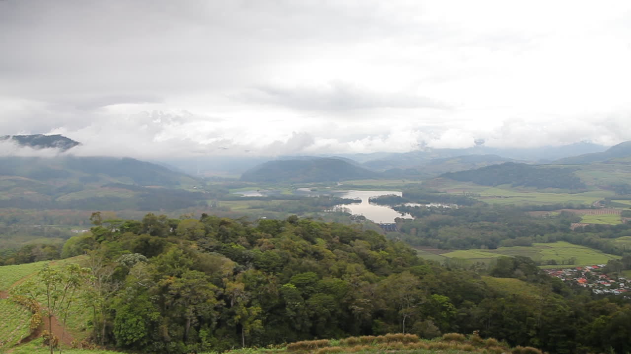 Beautiful moving shot of lookout platform overlooking Costa Rican valley below on lush hacienda